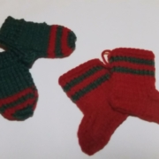 two small green and red mittens and two small red and green stockings